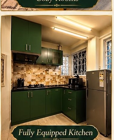 Fully equipped kitchen with dark green cabinetry